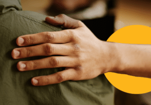 A comforting hand on a shoulder, symbolizing support and connection.
